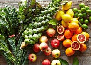 a group of fruits and vegetables on a wood surface Healthy Weight Loss Diets Hertfordshire